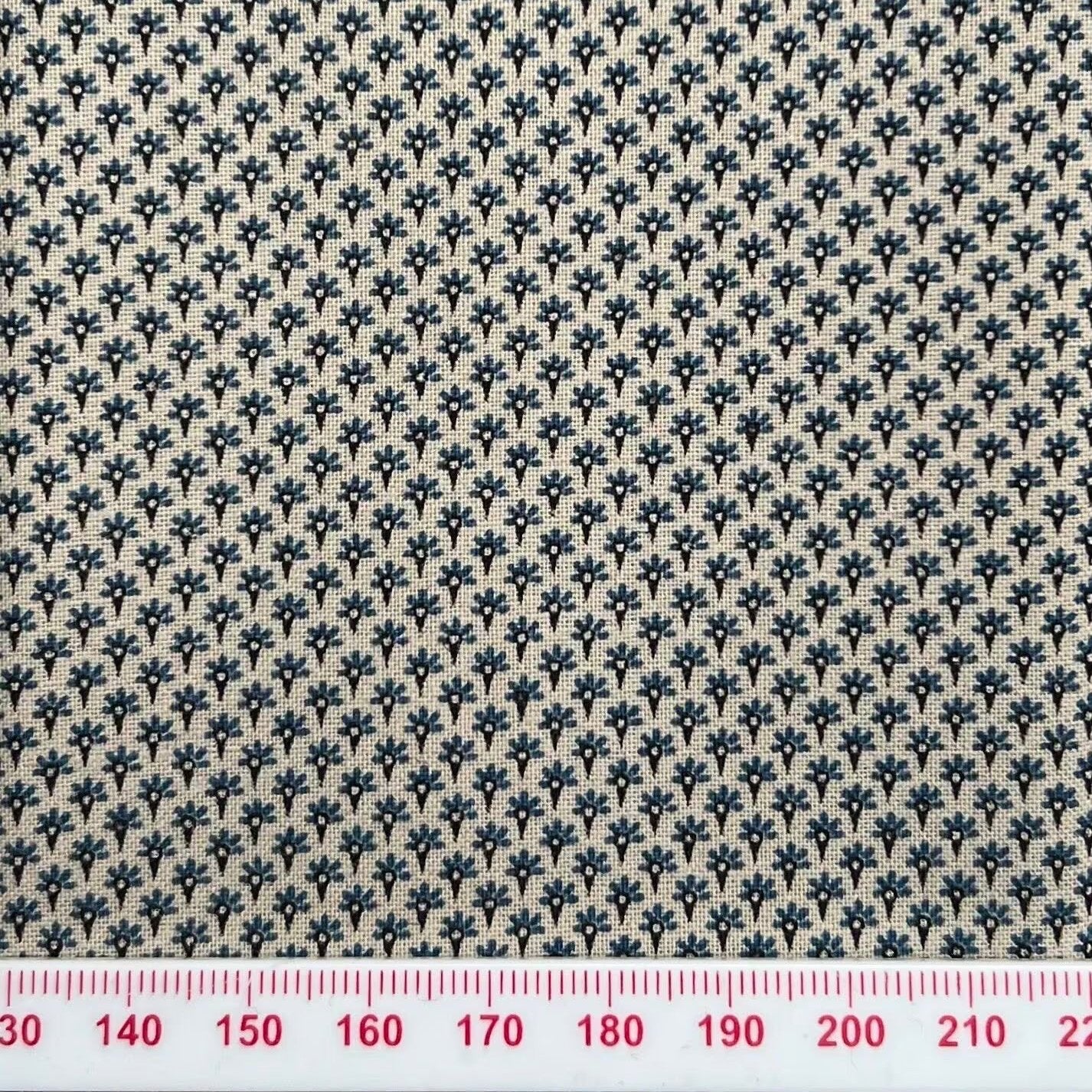 Tiny blue pattern on beige cotton