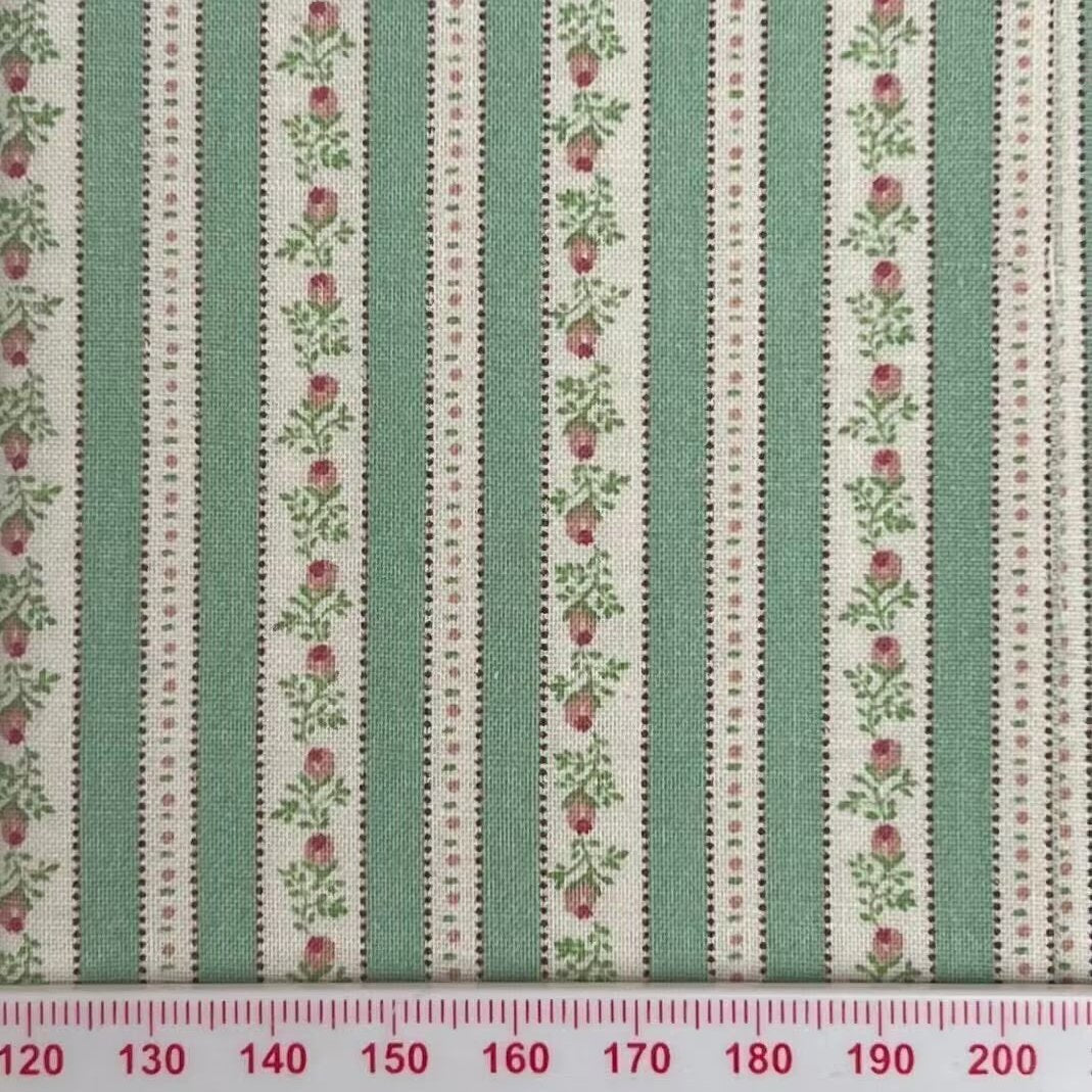 Green and cream stripes with pink flowers running through