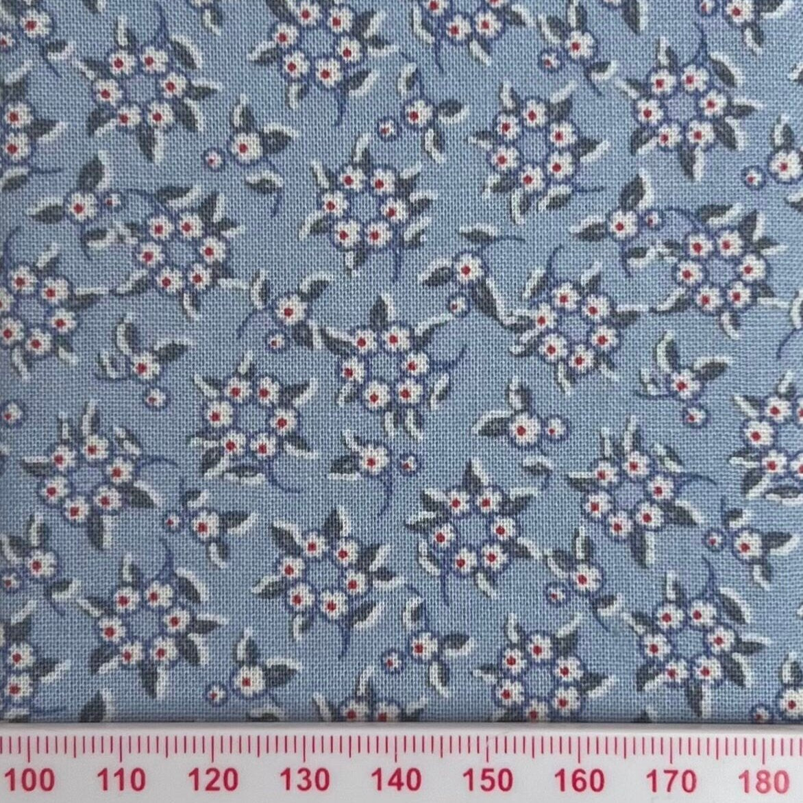 White and red flower rings on blue cotton