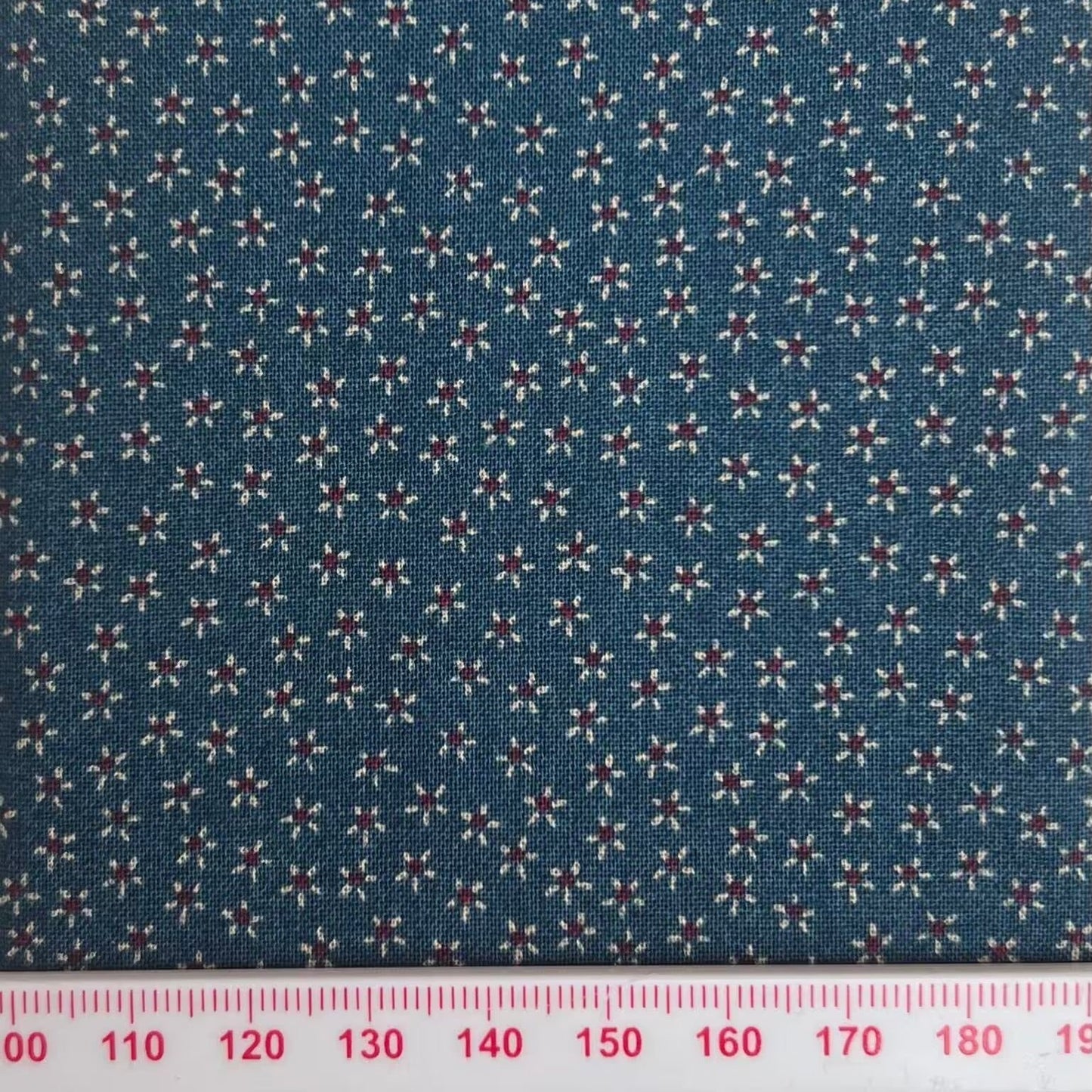 Tiny flowers on a blue cotton