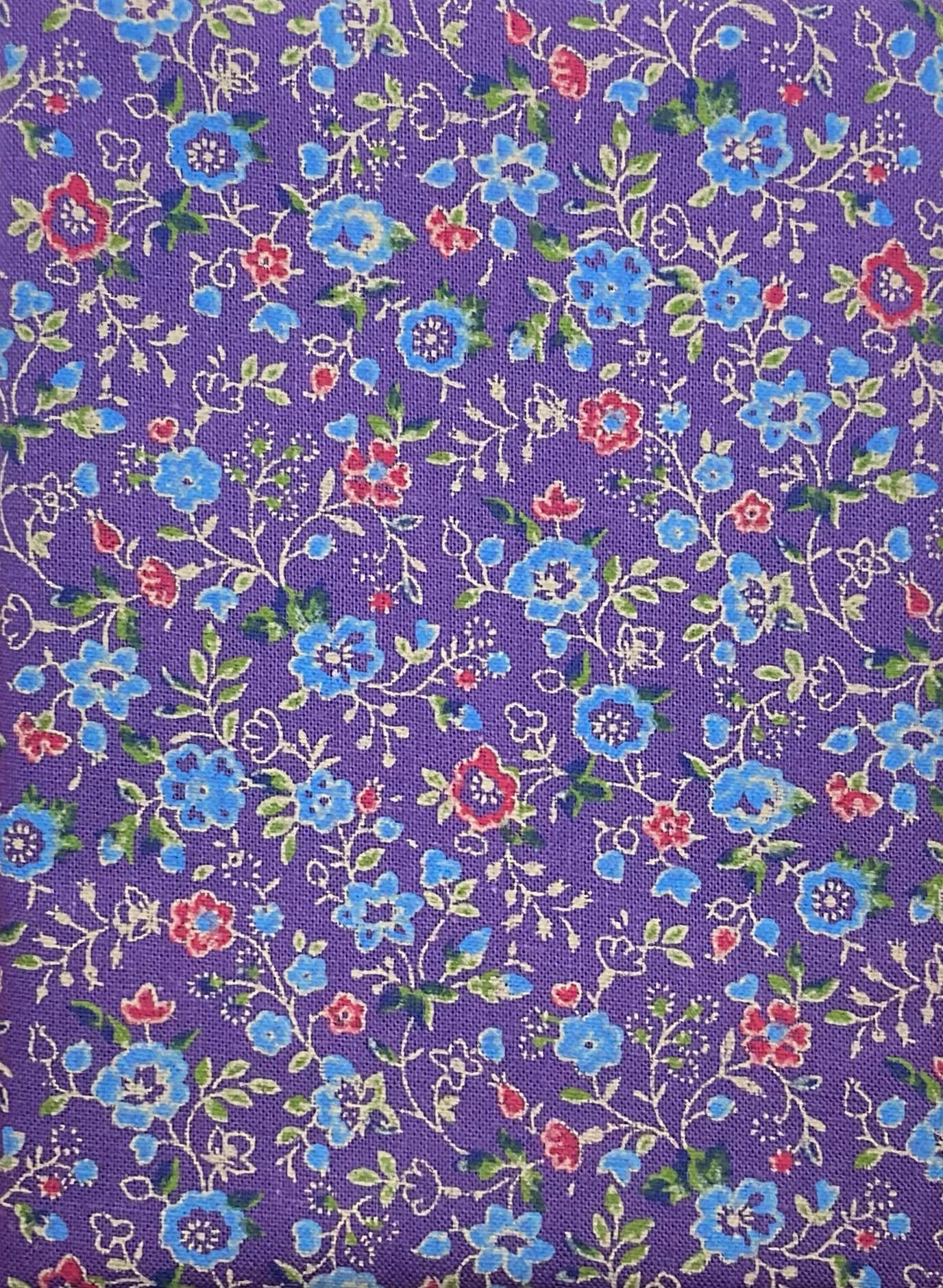 Vibrant blue are red floral print on a purple cotton