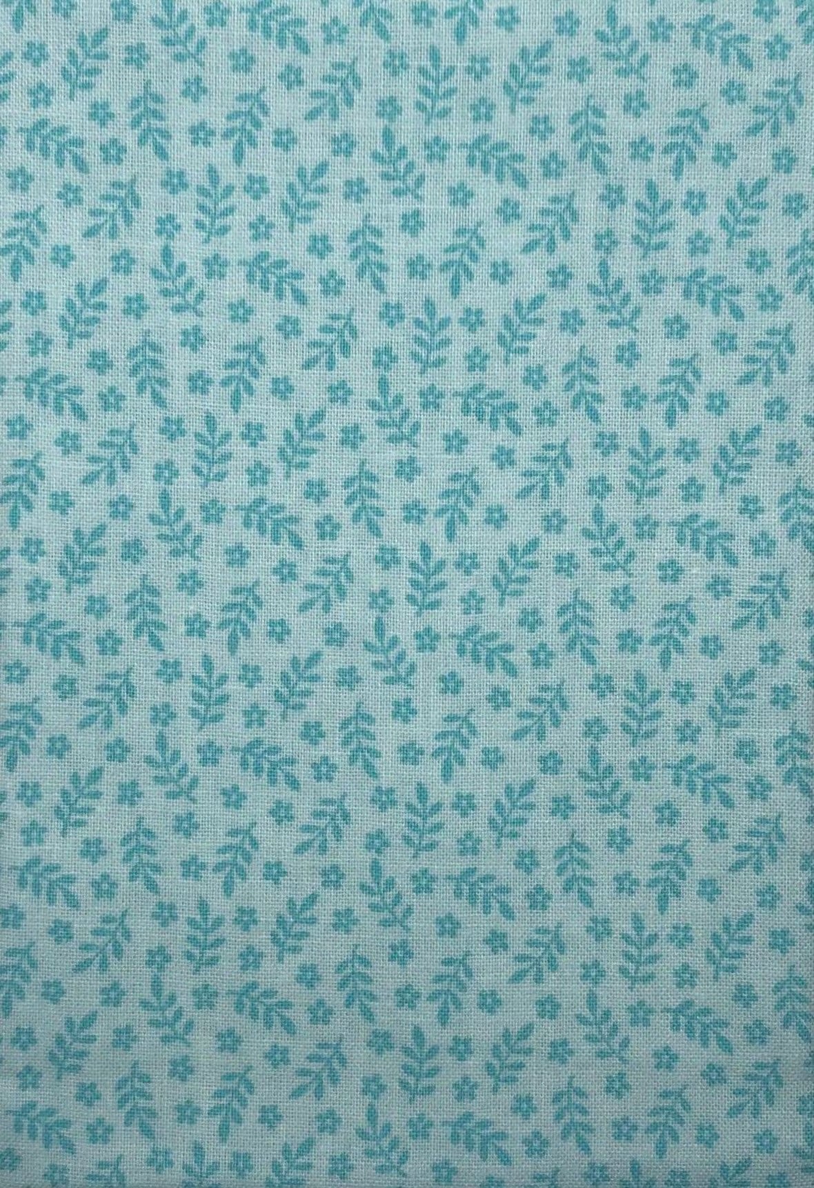 Leaves and flowers on a green cotton