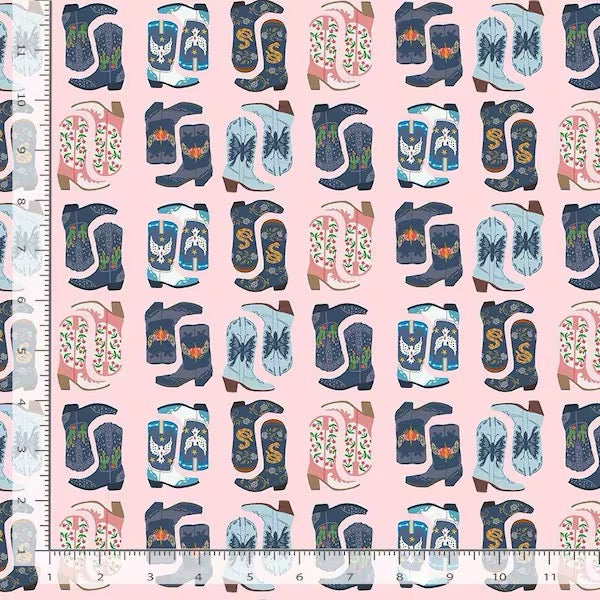 Cowboy boots on blush pink cotton