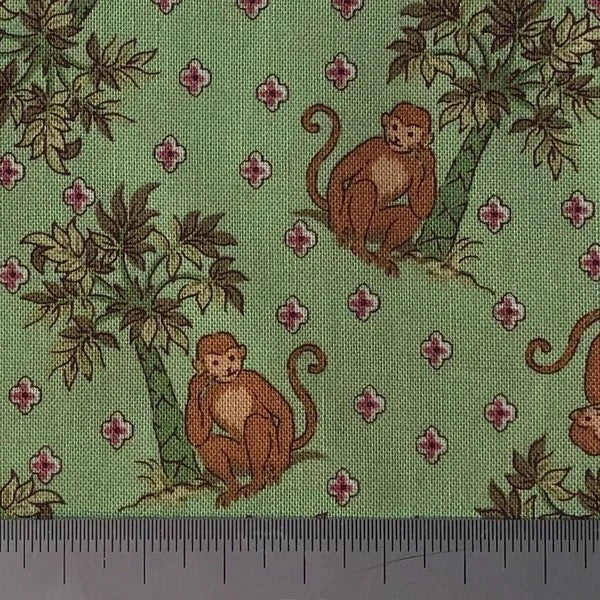 Monkeys on green cotton