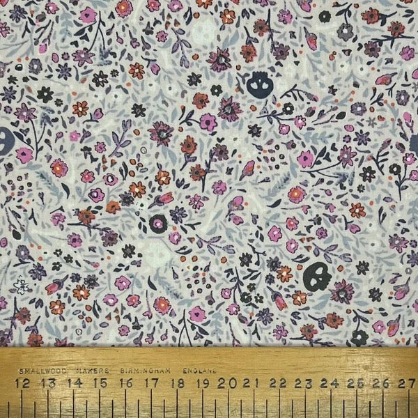 Flowers and skulls on a violet cotton