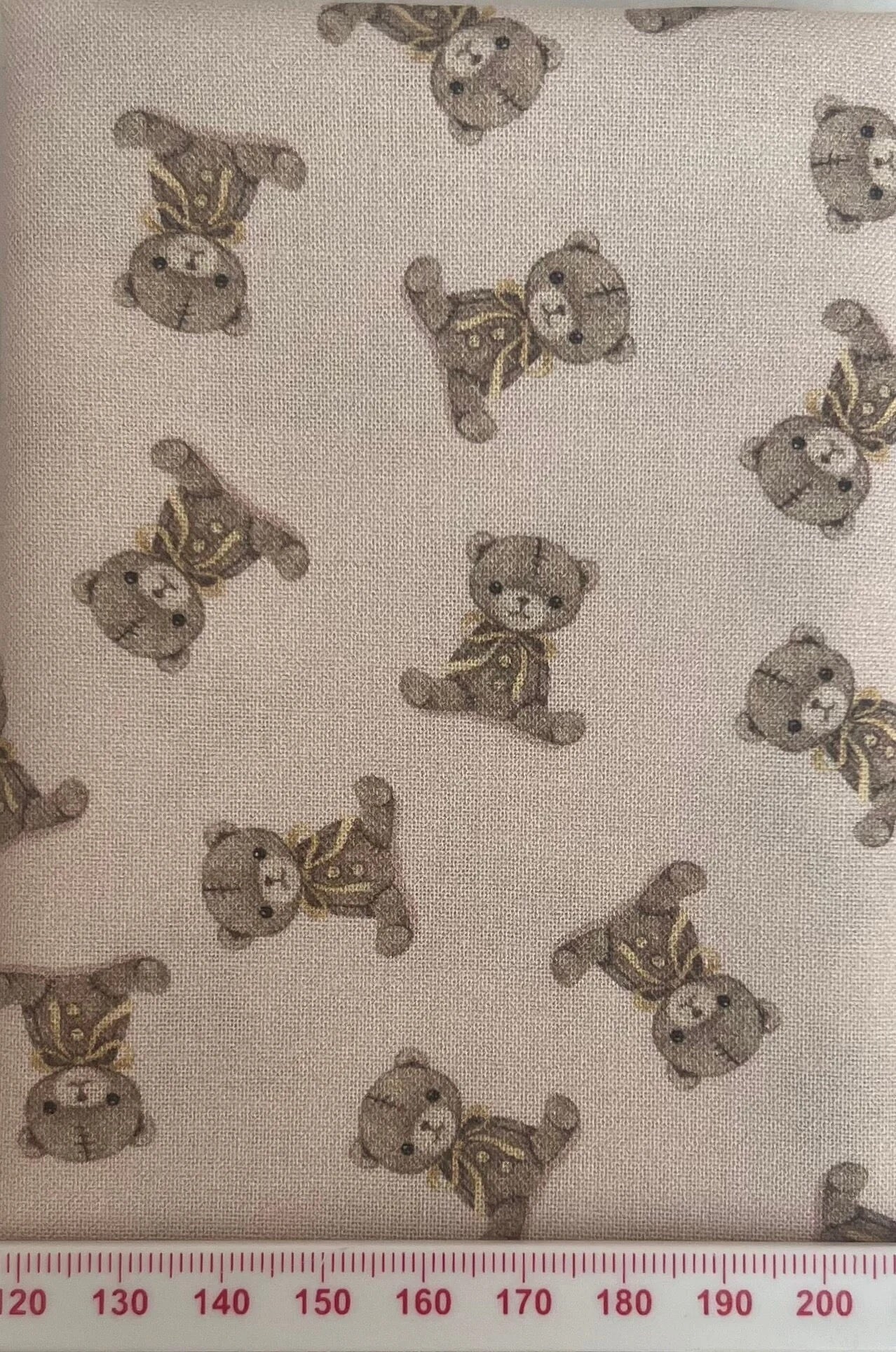 Teddy bears on a pale pink cotton