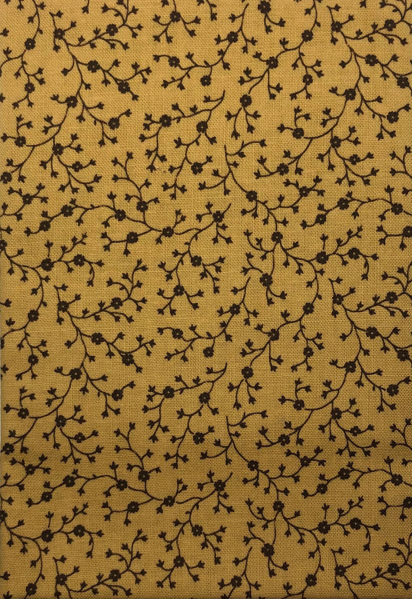 Brown floral branches on mustard cotton