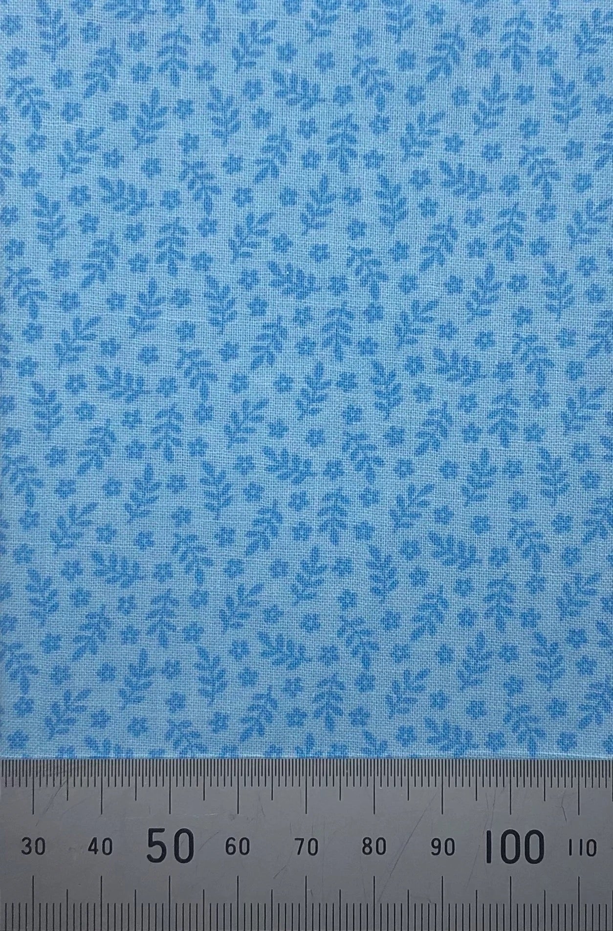 Leaves and flowers on a blue cotton
