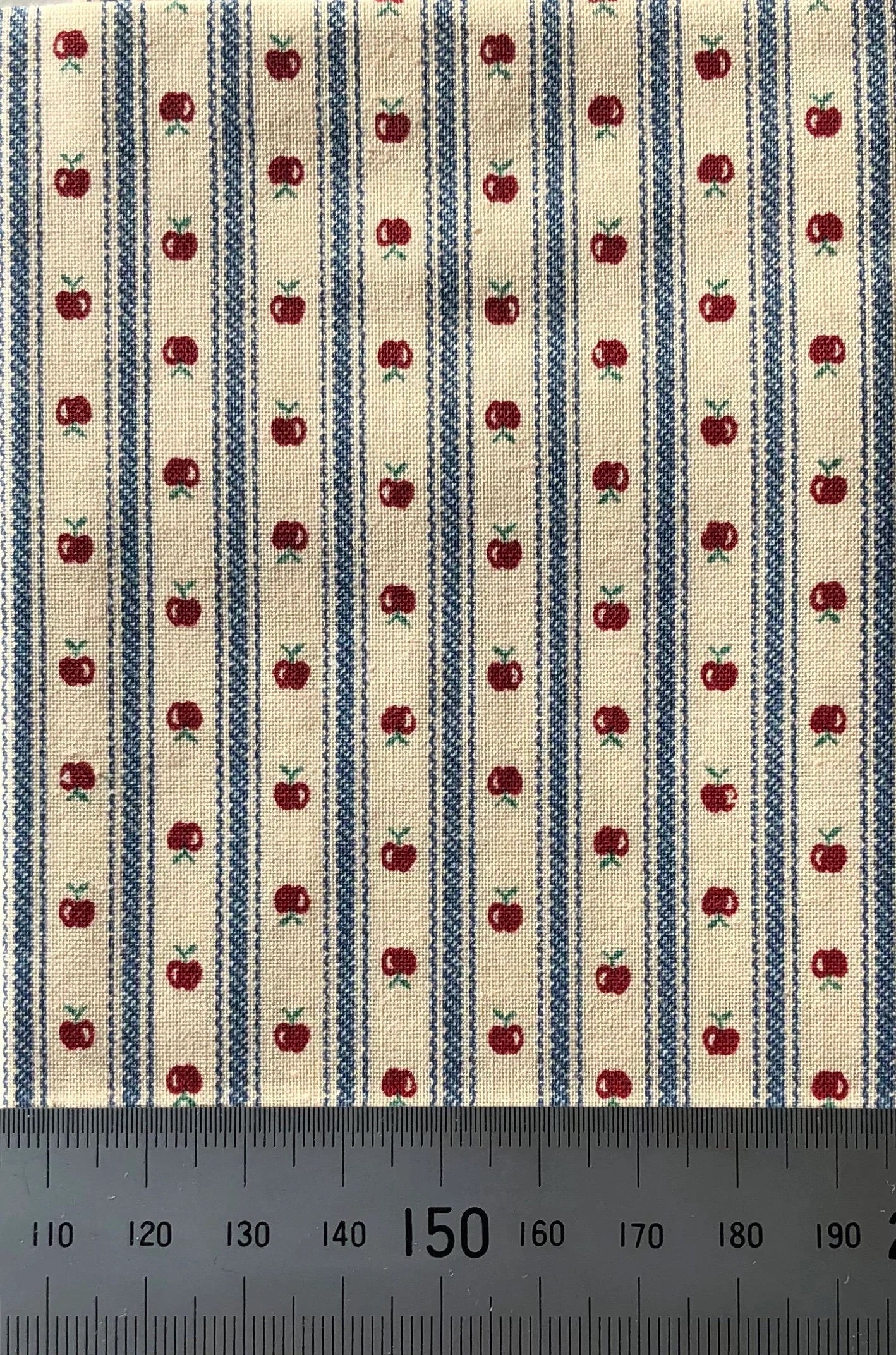Tiny apples on cream with blue stripe