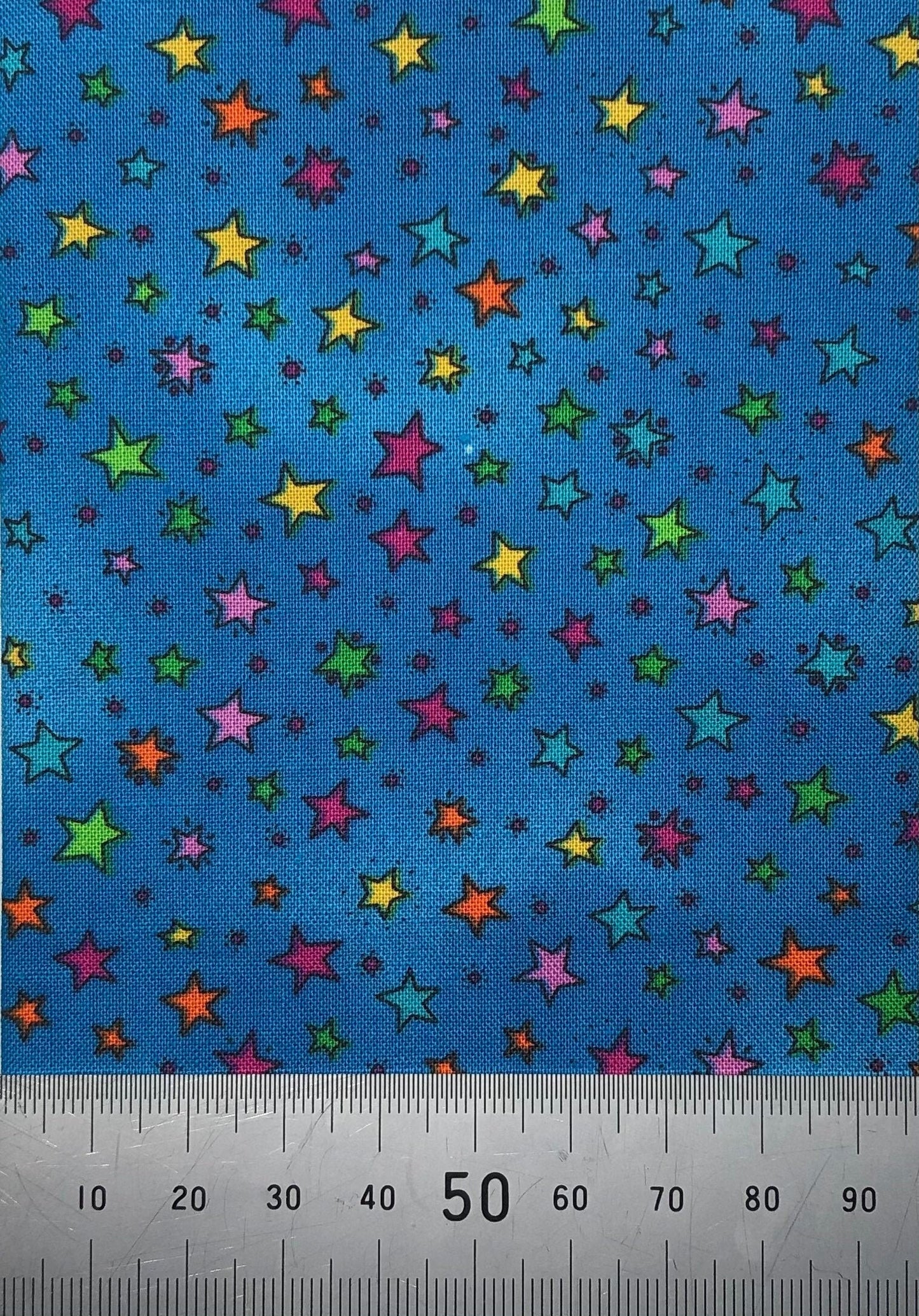 Multi coloured stars on a bright blue cotton (fat quarter)