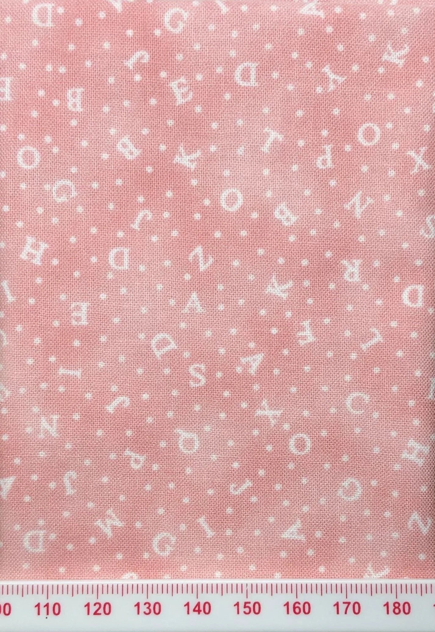Alphabet on pink cotton