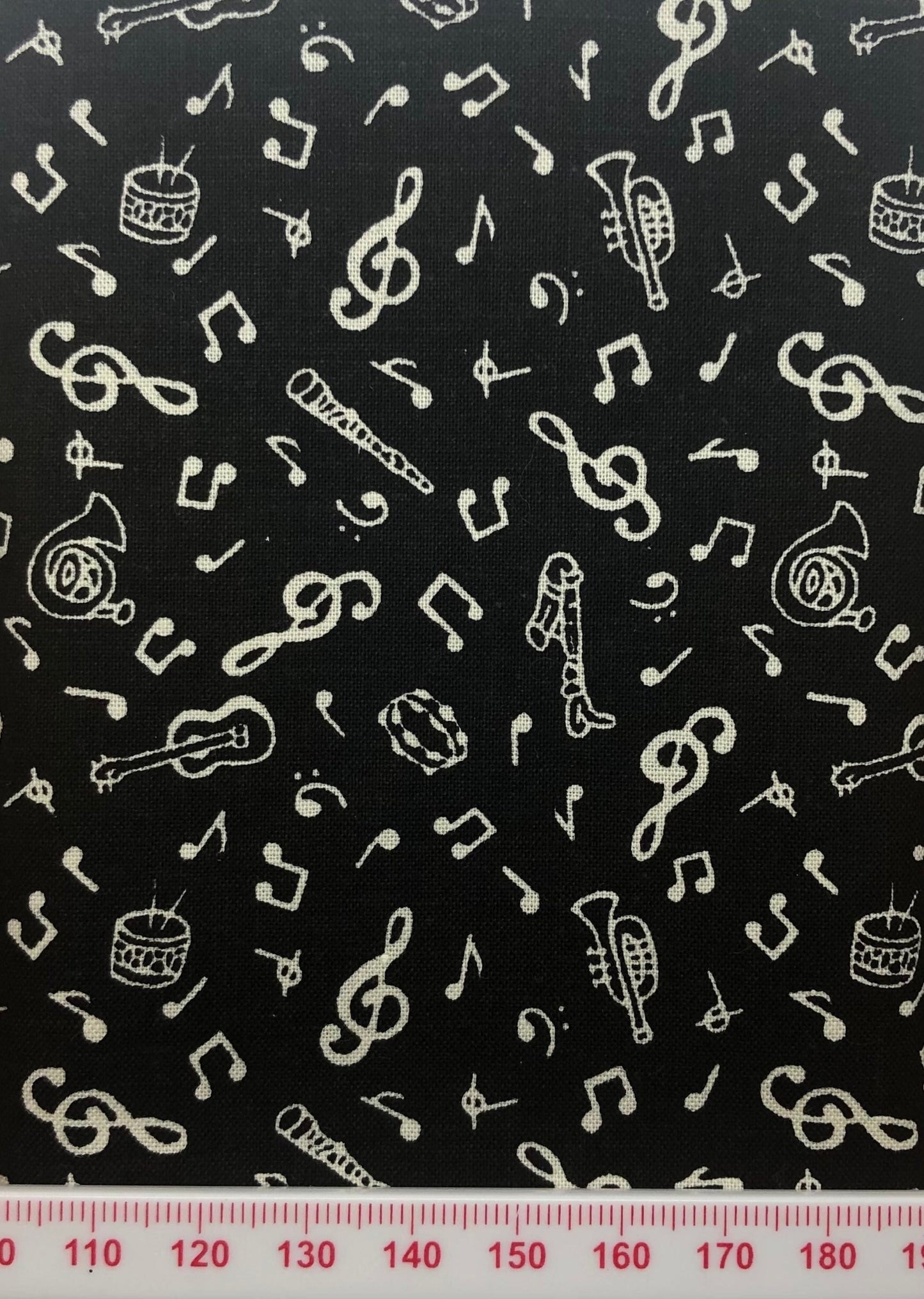 Musical symbols on black cotton