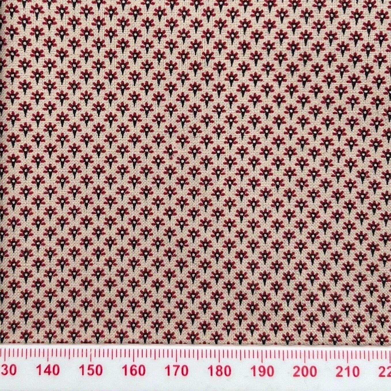 Tiny red pattern on beige cotton