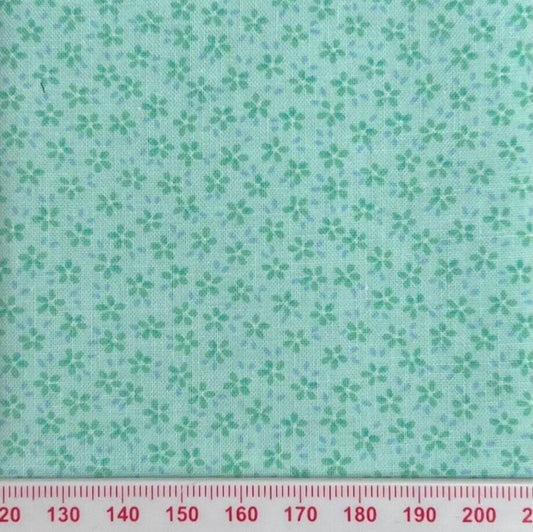 Tiny flowers on green cotton