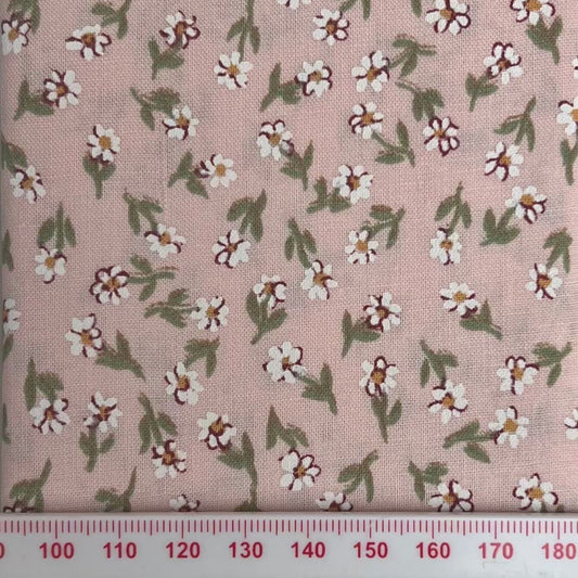 White flowers on a pale pink cotton