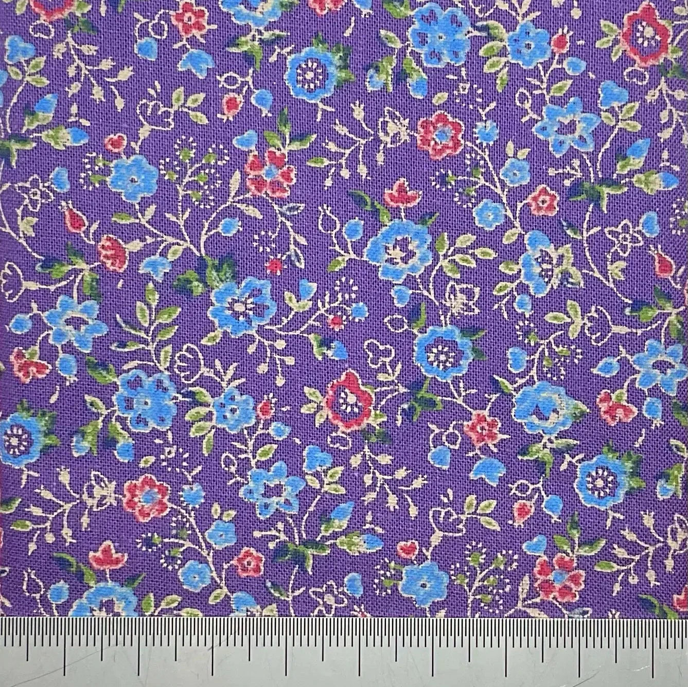 Vibrant blue are red floral print on a purple cotton