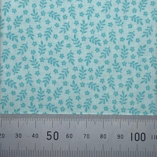 Leaves and flowers on a green cotton
