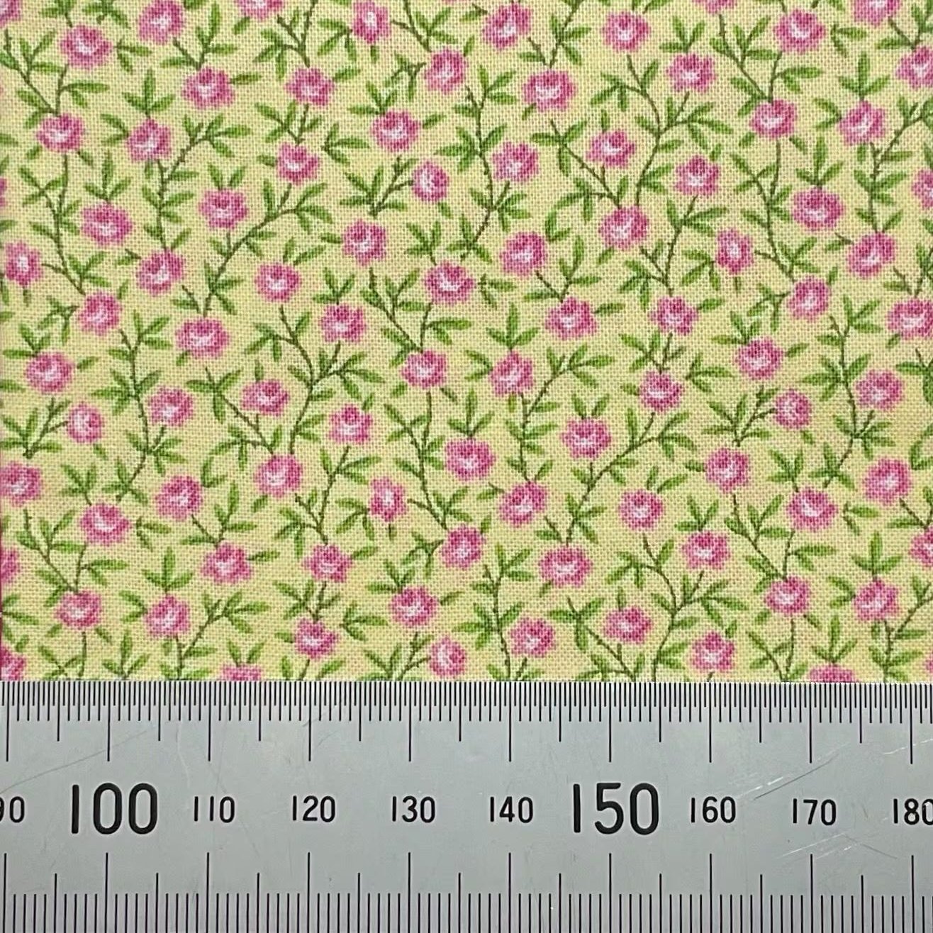 Pink flowers on yellow cotton