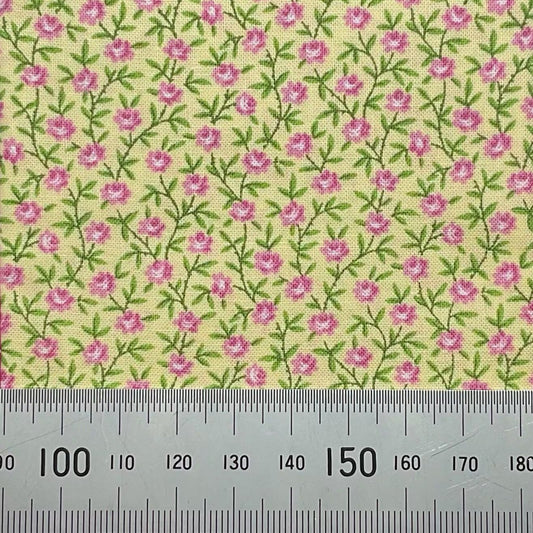 Pink flowers on yellow cotton