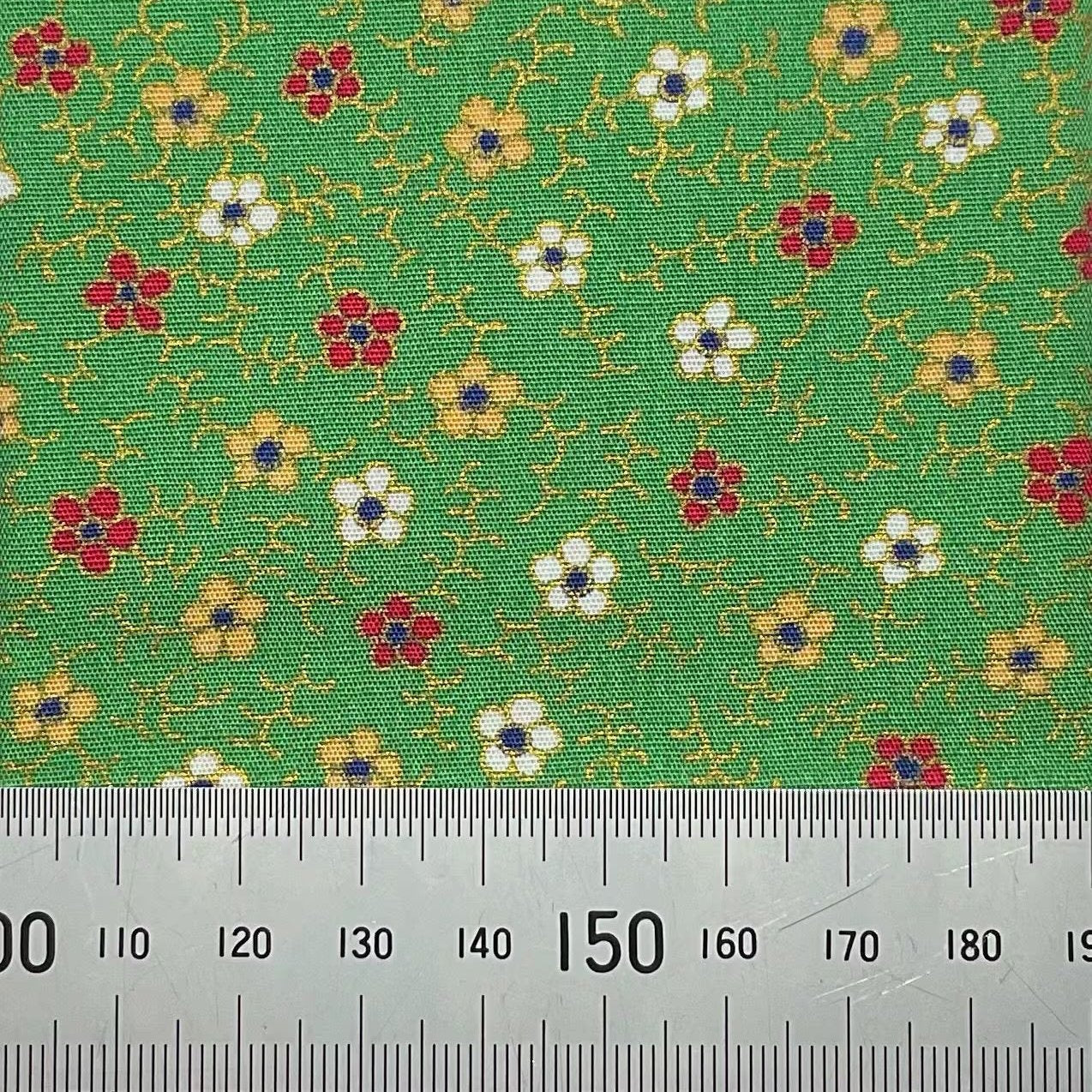 Floral print on green cotton with metallic detailing