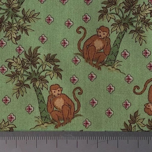 Monkeys on green cotton