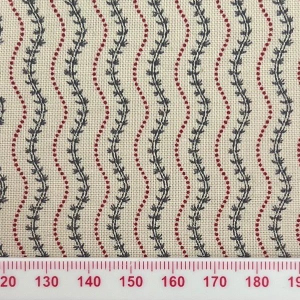 Green vines between red squiggles on beige cotton