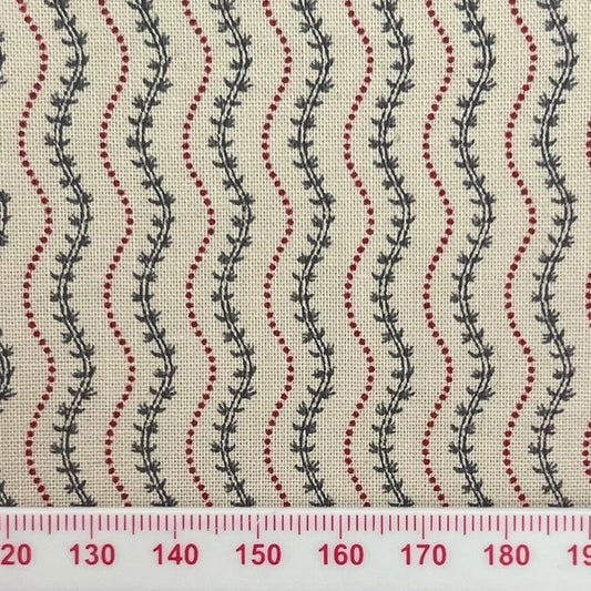 Green vines between red squiggles on beige cotton