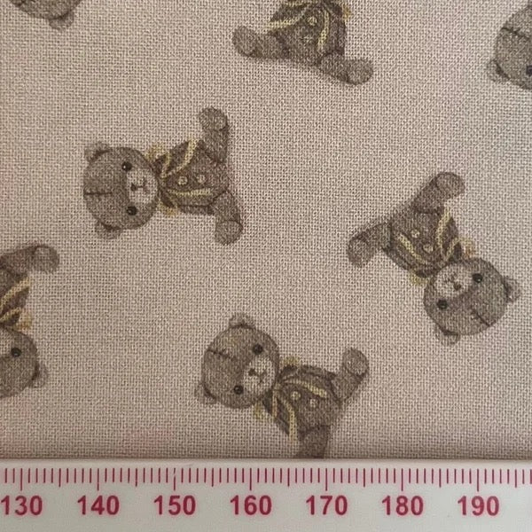 Teddy bears on a pale pink cotton