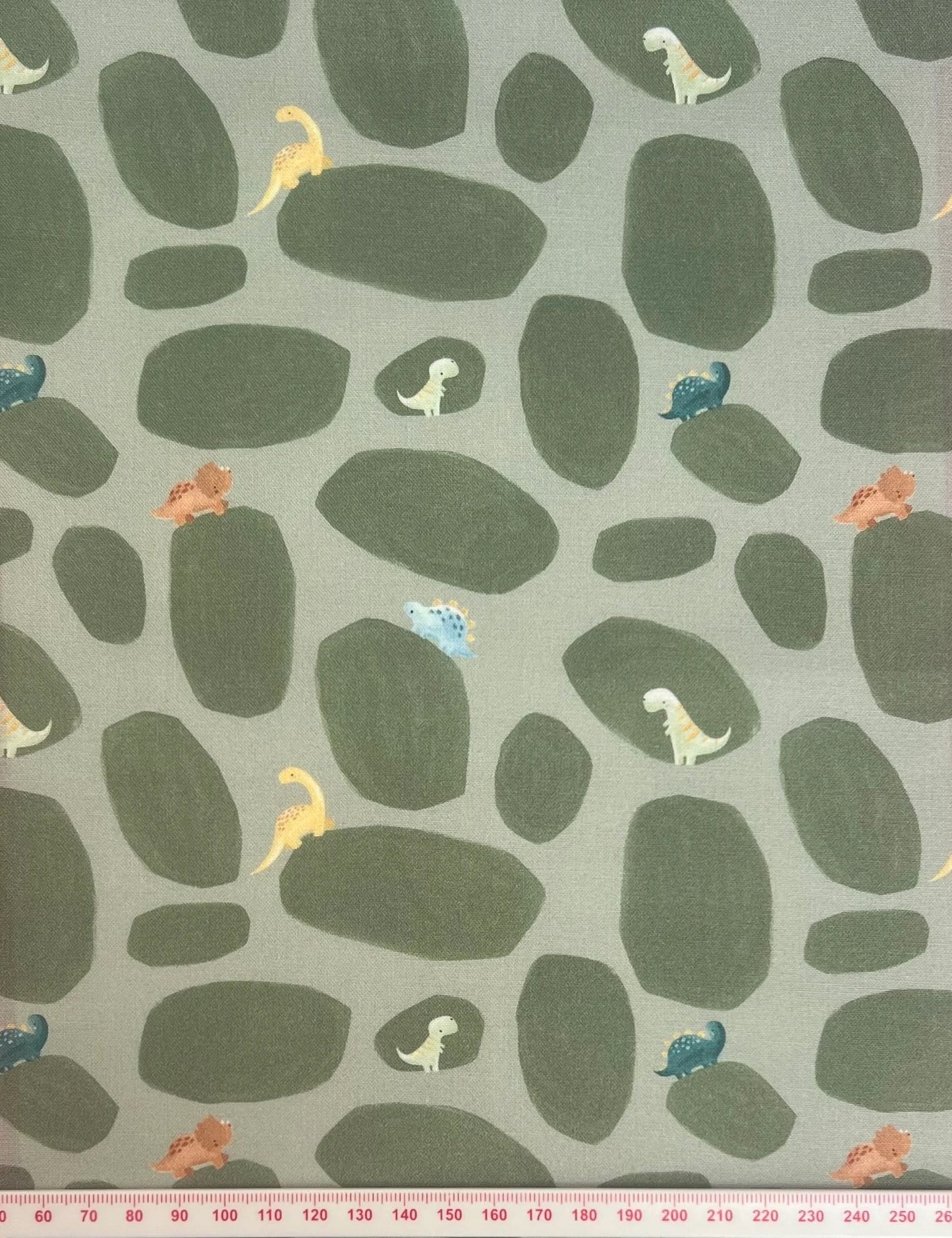 Small dinosaurs on green cotton