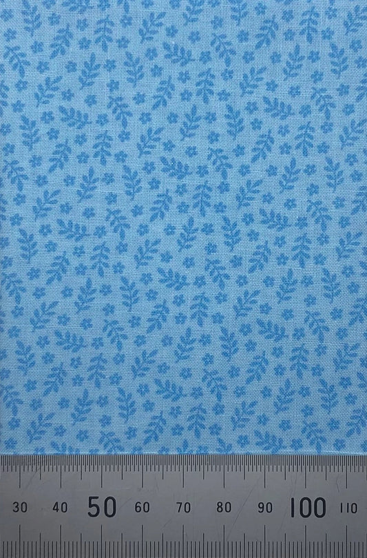 Leaves and flowers on a blue cotton