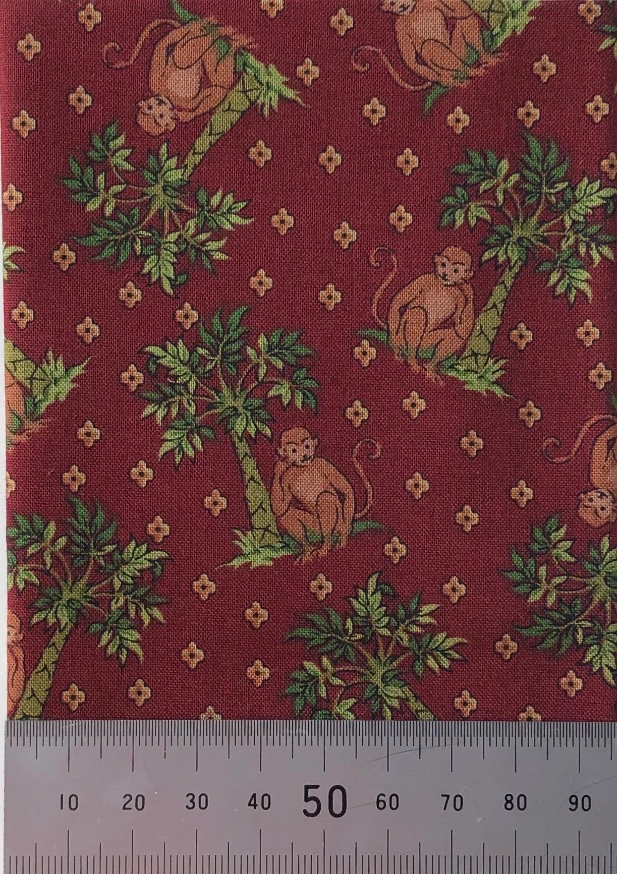 Monkeys on a burgundy cotton