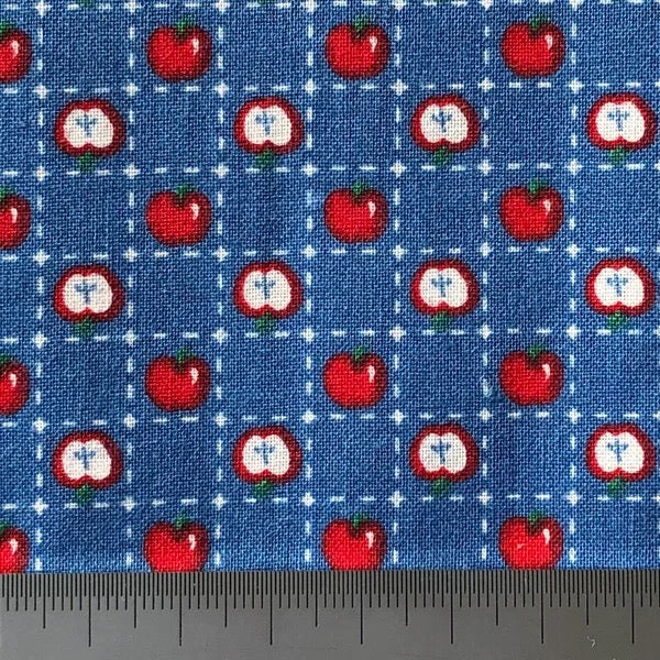Apples on blue cotton