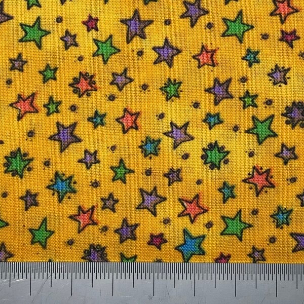 Multi coloured stars on a bright yellow cotton