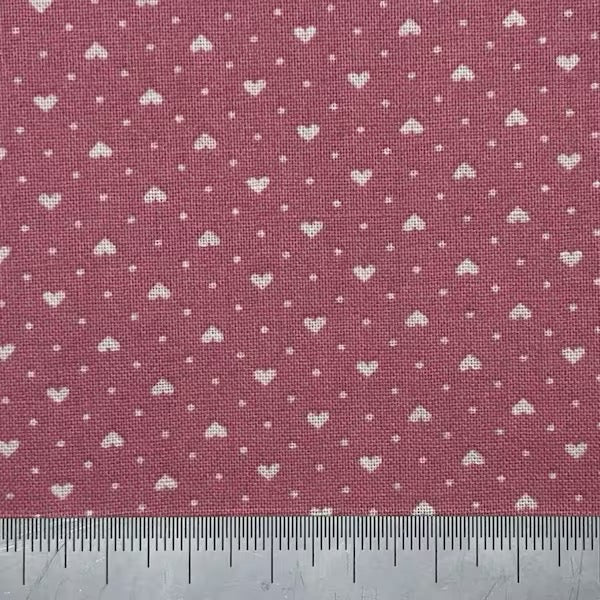 White hearts on a dark pink cotton