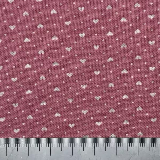 White hearts on a dark pink cotton