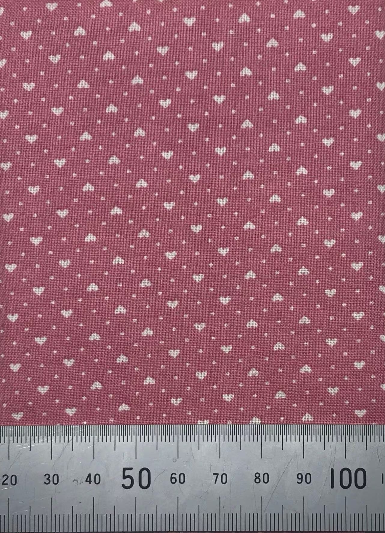 White hearts on a dark pink cotton