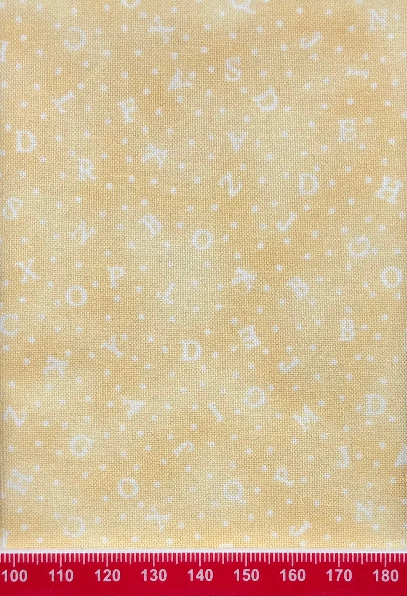 Alphabet on pale yellow cotton