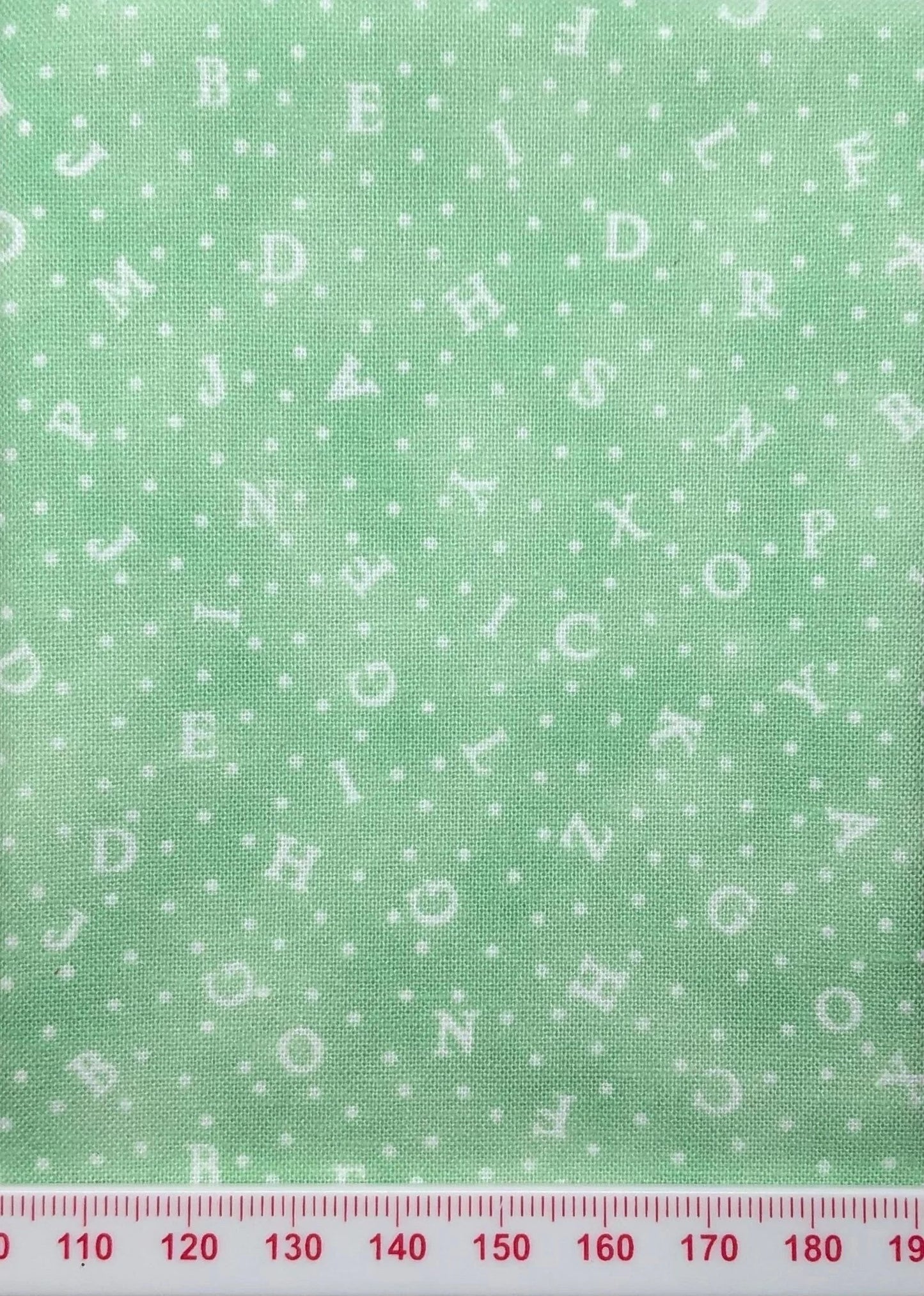Alphabet on green cotton