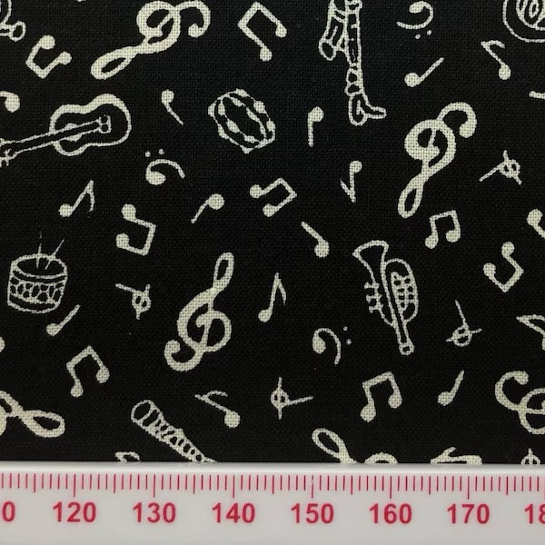 Musical symbols on black cotton