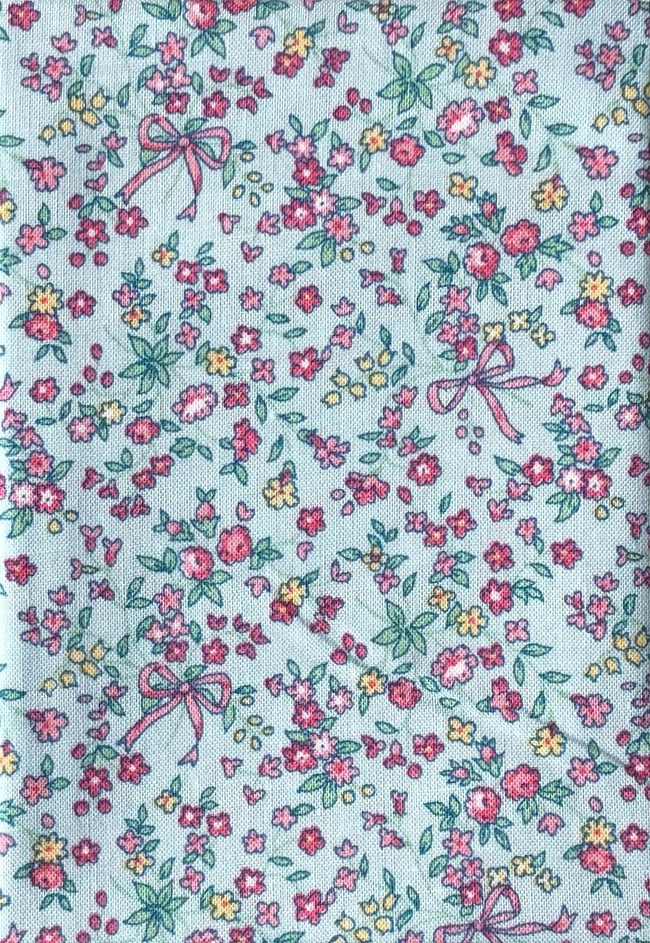 Flowers and ribbons on blue cotton