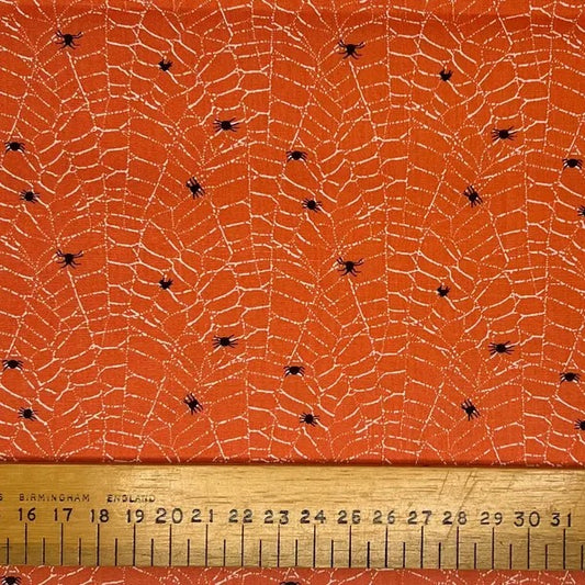 Black spiders and web on a orange cotton (fat quarter)