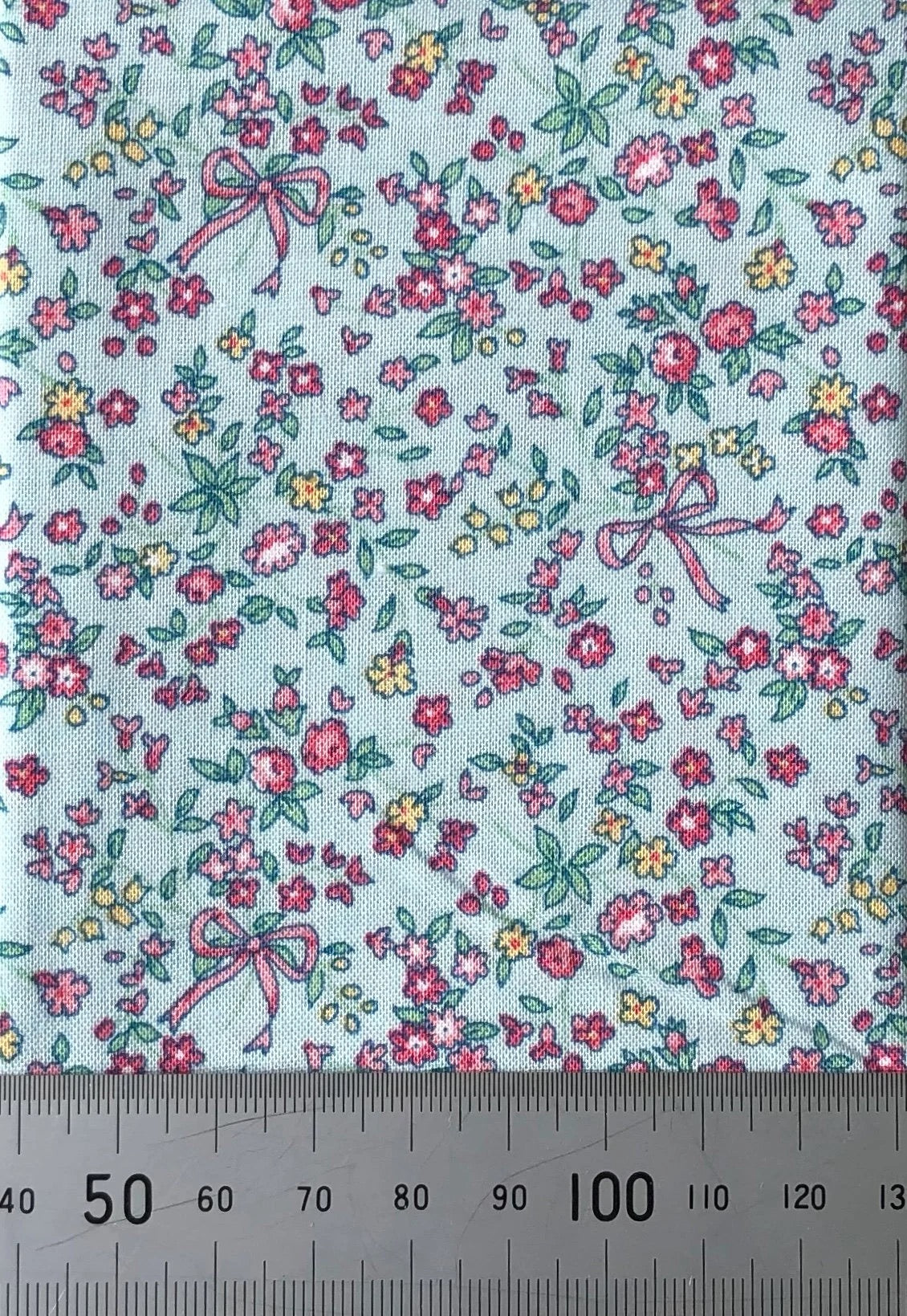Flowers and ribbons on blue cotton